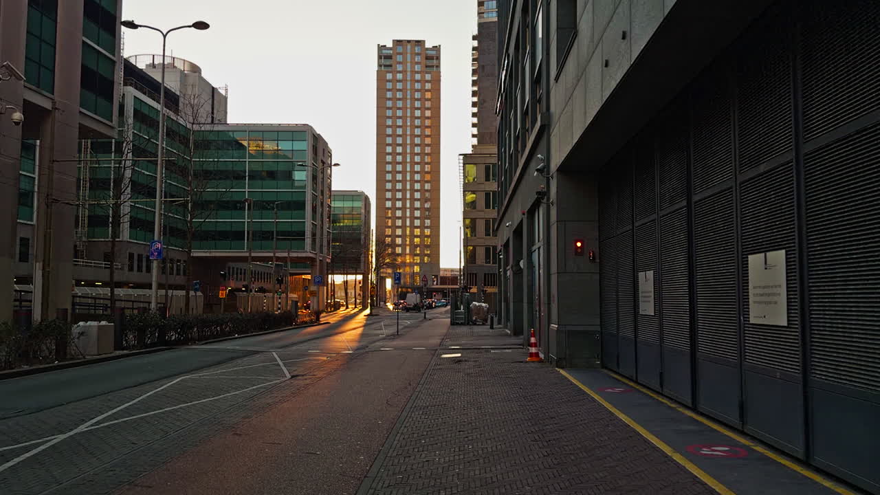 European modern city urban town in the Netherlands in the Hague with buildings skyscrapers in golden hour early evening before sunset with sunlight of setting sun, wide low angle view