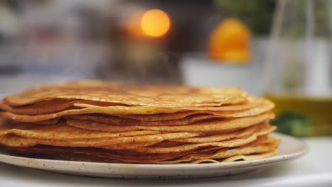 anonymous cook putting a pancake on top of another pancake