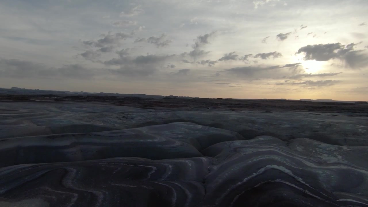 fly over of bentonite hills in hankesville utah during sunset and dramatic shadows