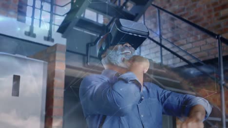 animation of network of connections over african american senior man wearing vr headset at office