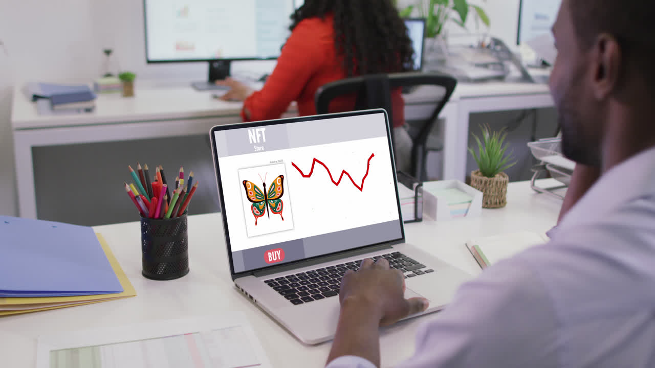 video de un hombre afroamericano trabajando en una computadora portátil con nft en la pantalla