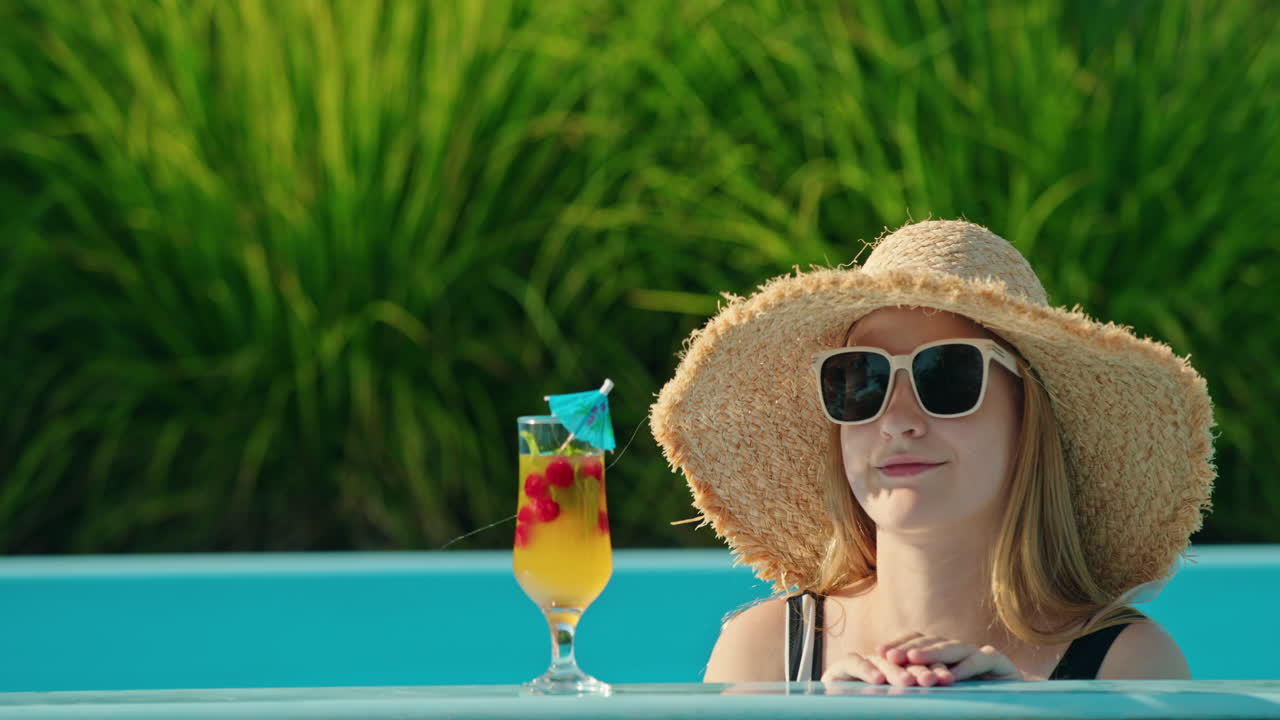 Woman relaxing poolside with a cocktail