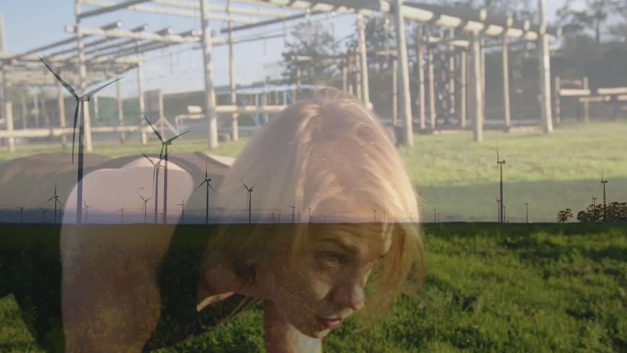 Donna che si allena all'aperto, con animazione di turbine eoliche su un paesaggio verde.