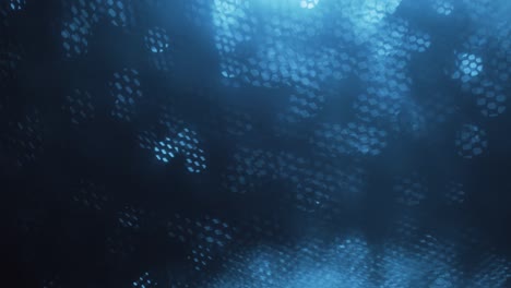 blue abstract optical blurred background. optical bokeh overlapped by moving honeycombs.