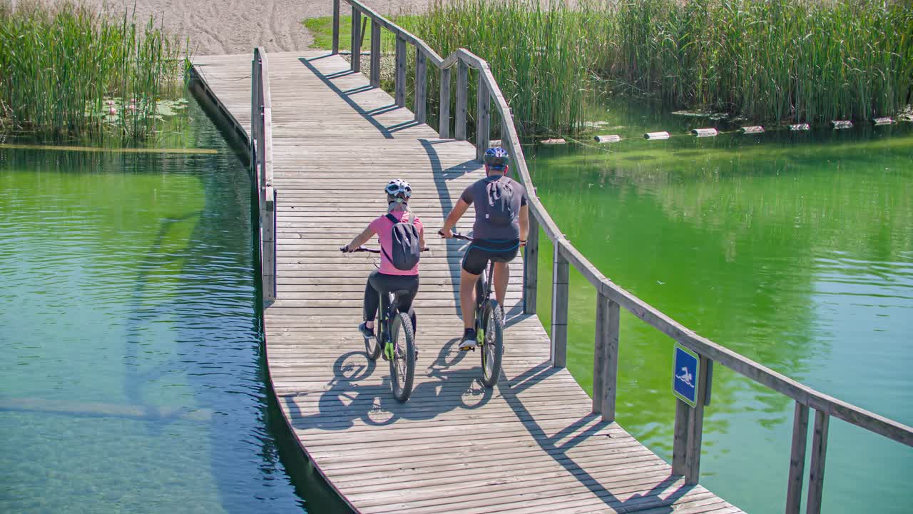 Couple cycling back from Radlje ob Dravi natural pool