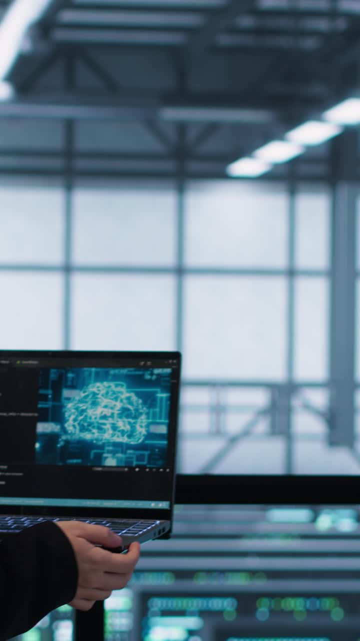Vertical video Programmers coding on laptop using artificial intelligence in server farm