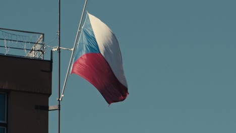 czech national flag on the wind in slow motion under blu sky