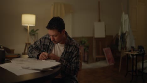 artist working on sketches at night