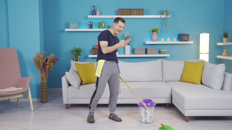 happy man cleaning pleasantly with phone in hand.