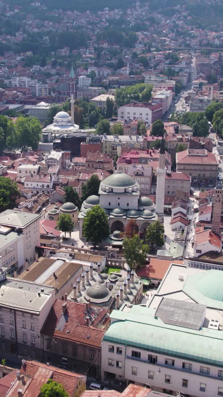 Aerial view of Gazi Husrev beg Mosque and surrounding cityscape in Sarajevo, Bosnia and Herzegovina, showcasing Ottoman architecture and urban landscape. Vertical Video