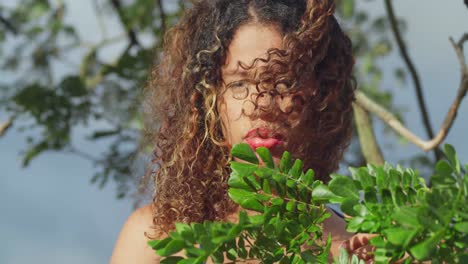 A-curly-haired-young-girl-in-a-short-blue-dress-enjoys-a-tropical-park-on-the-Caribbean-island-of-Trinidad