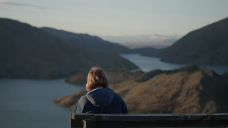 Blonde-woman-resting-on-bench-during-golden-hour