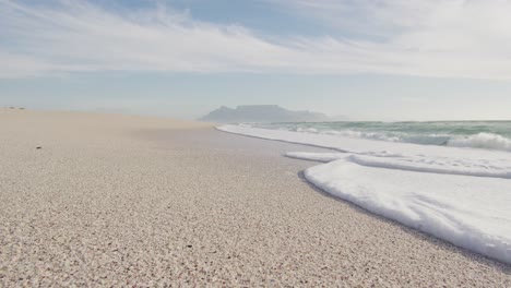 seascape, beach and waving sea at sunset