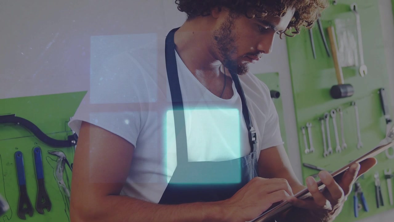 Male tech tapping tablet and consulting bike guide, creating blue overlays drifting over chest
