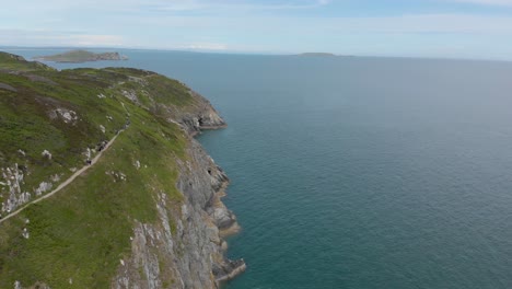 Flying-over-beautiful-green-mountain-landscape-and-blue-sea