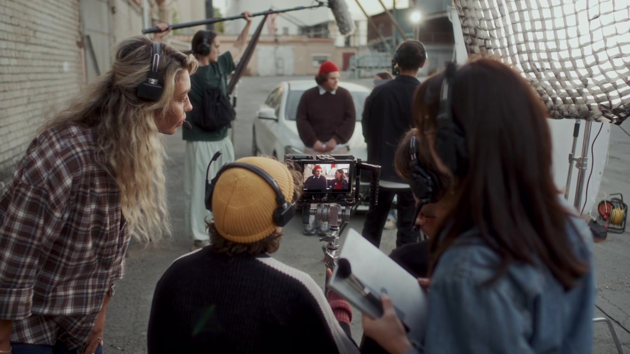 Team of Young Filmmakers Discussing Live Take on Camera Monitor