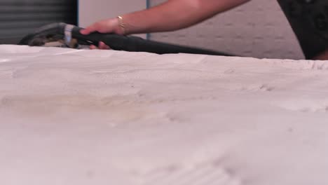 professional chemical cleaning of mattress with vacuum cleaner, close up