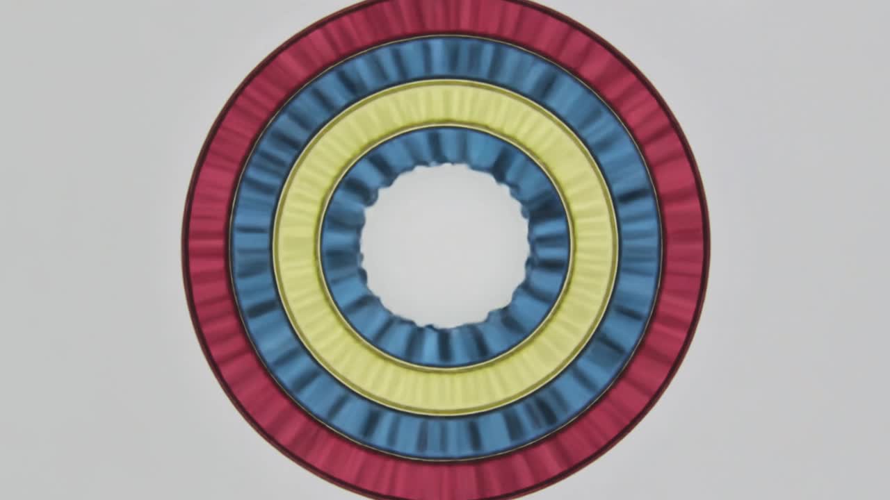 Animating centered rings shifting ripples as playback starts on gray background, red blue yellow