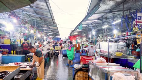 vendors and shoppers at a busy fish market