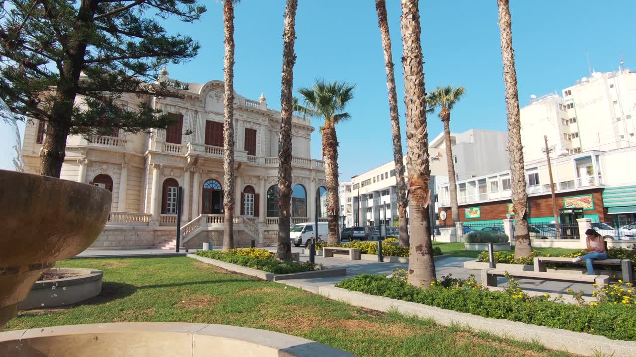 Garden fountain in the surrounding area of Limassol Municipal Library in Cyprus - Wide Crane pan shot