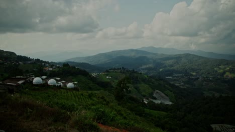 mountainous landscape with farmland and domes