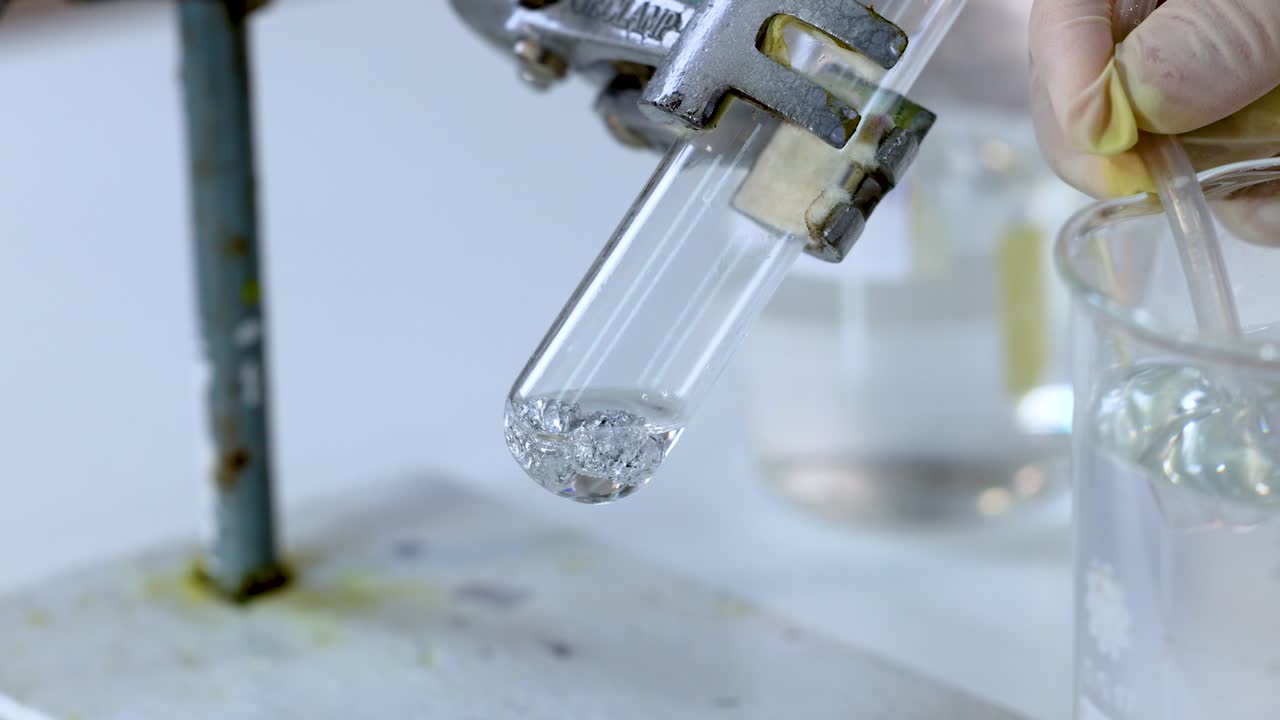Chemical reaction producing gas bubbles in test tube