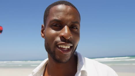 happy man standing at beach on a sunny day 4k