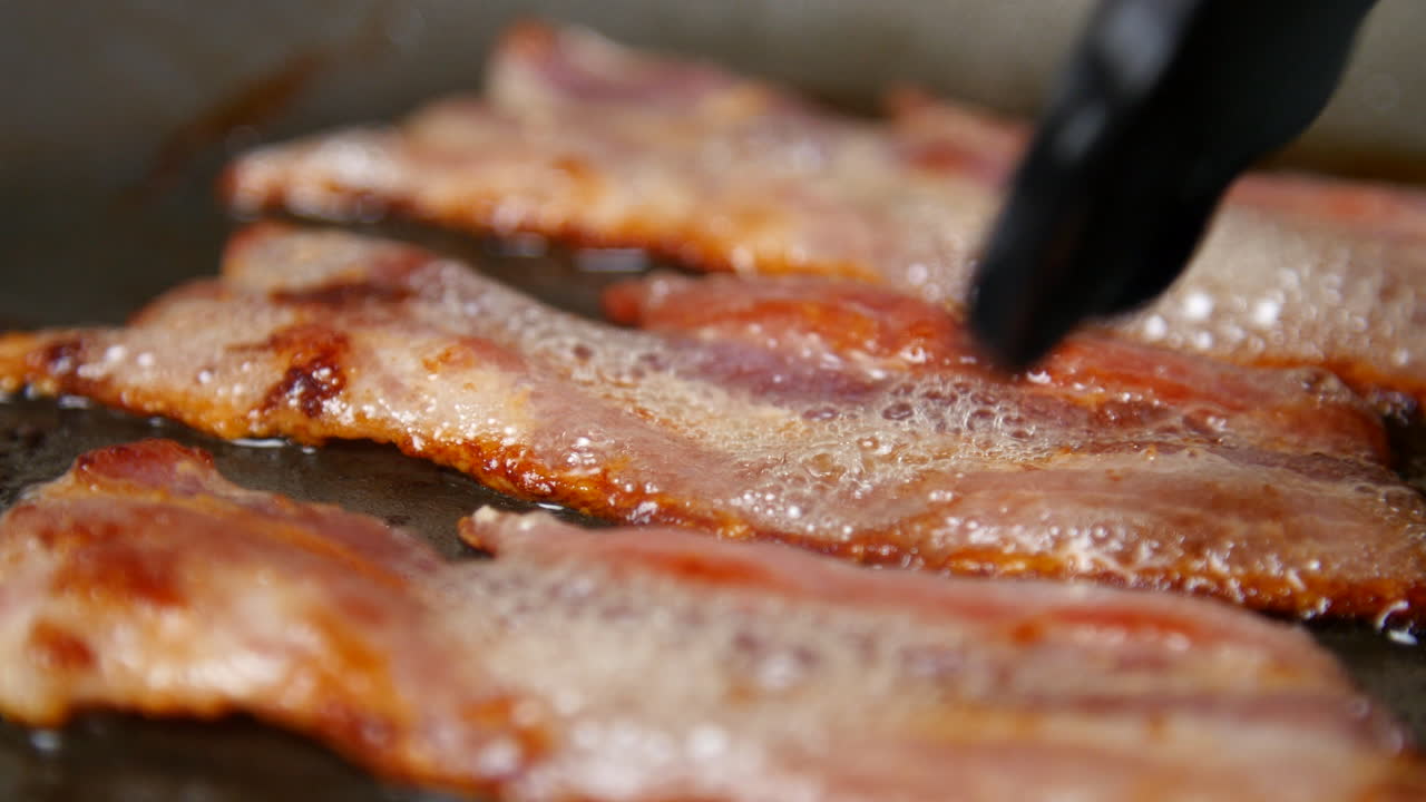 Sizzling Crispy Bacon Frying in a Pan