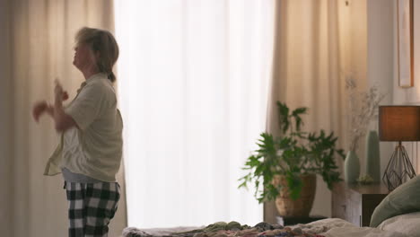 woman in bedroom near window