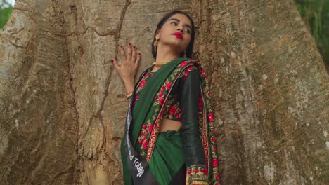 Wearing-traditional-Indian-clothes,-a-young-girl-enjoys-her-day-at-a-tropical-park-in-the-Caribbean