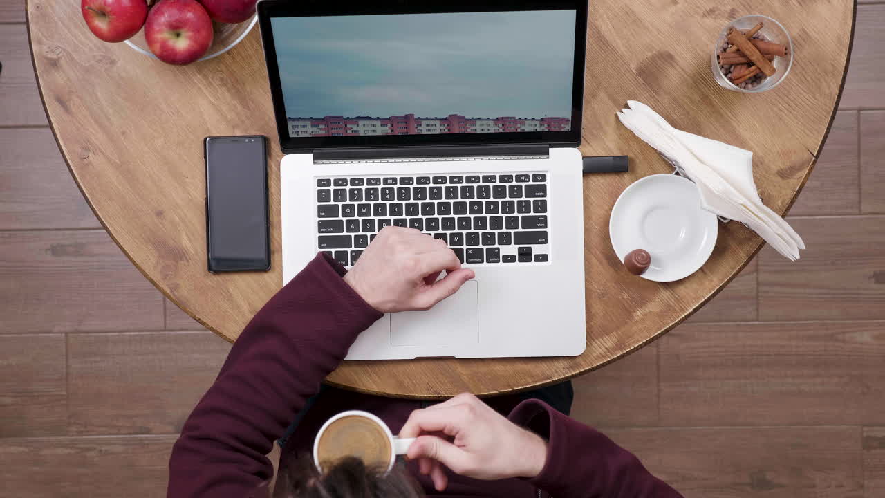 Working at a desk with a laptop and coffee