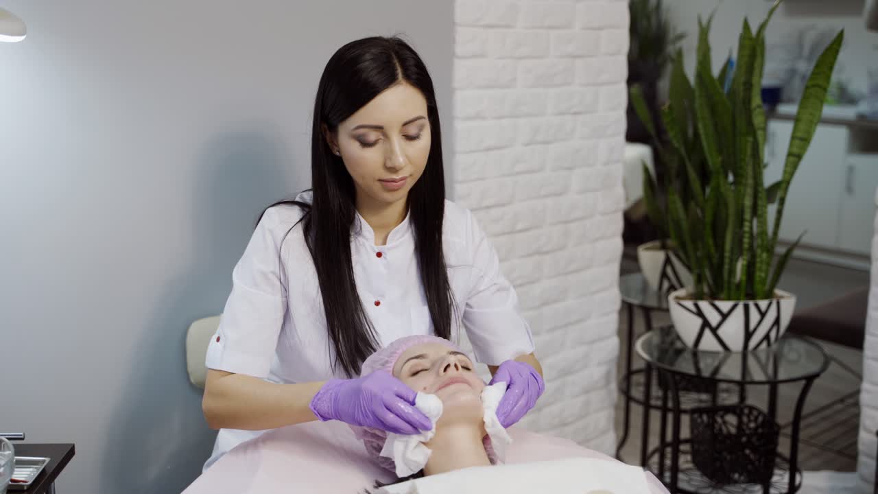 Skin care concept. Beautician is making a facial rejuvenation procedure for woman
