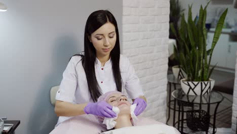 skin care concept. beautician is making a facial rejuvenation procedure for woman