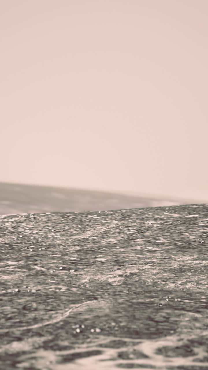 Serene waters shimmering under gentle sunlight with distant horizon