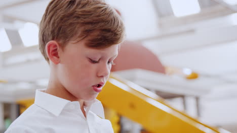 young white boy concentrating at science centre, close up