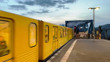 berlin underground train enters station during blue hour in kreuzberg