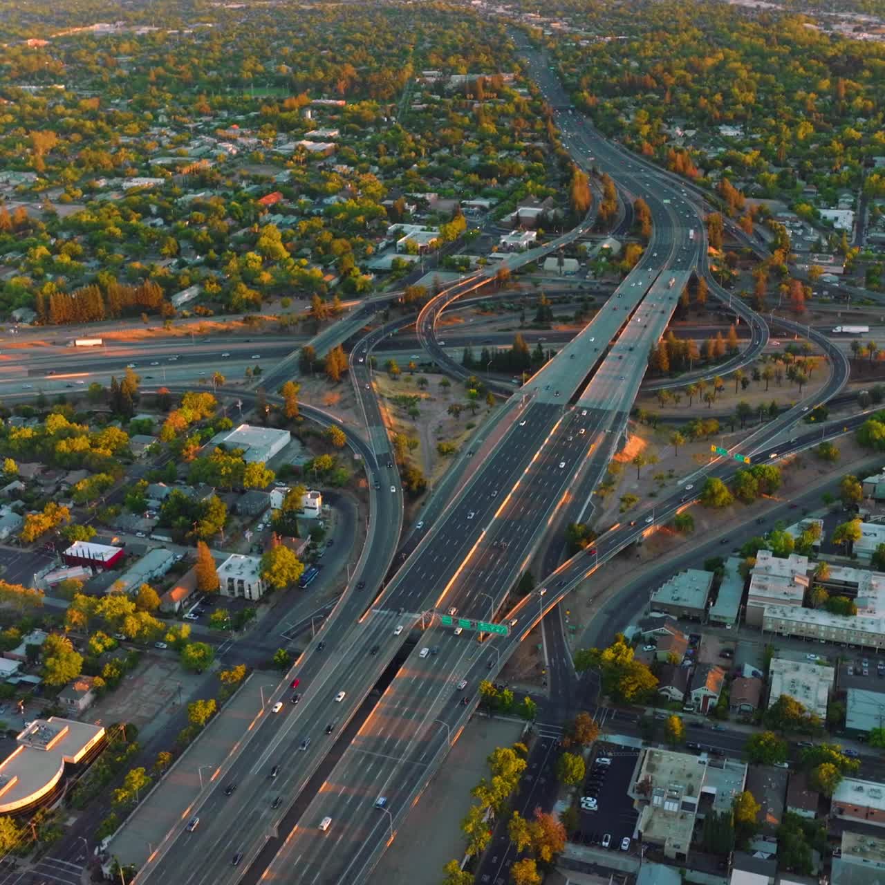 Huge impressive road junction in the city of Sacramento, California, USA. Vast urban panorama of green city from top view