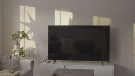 time-lapse of light moving from window on living room with tv and minimal design