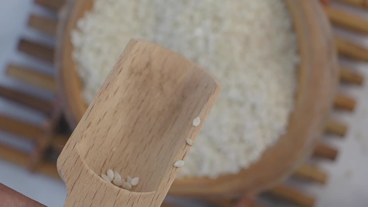 White Sesame Seeds in Wooden Scoop