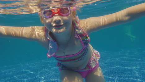 girl 6 years old learns to dive in the pool slow motion video