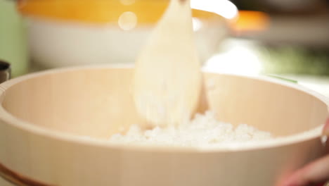 cooking sushi mixing rice in wooden plate