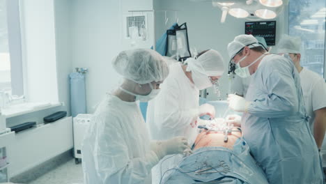 surgical team operates patient heart. cardiothoracic surgeons perform complicated coronary artery bypass graft surgery in sterile operating room