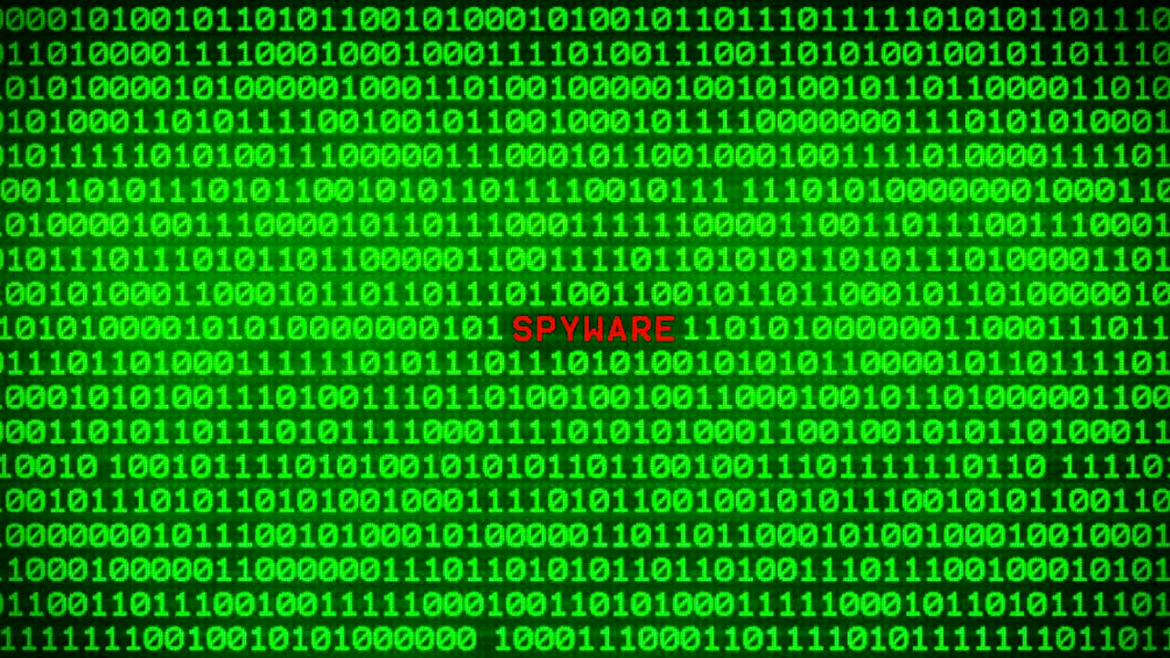 Spyware Word Revealing on Wall of Green Binary Code  Between Random Binary Data Matrix Background