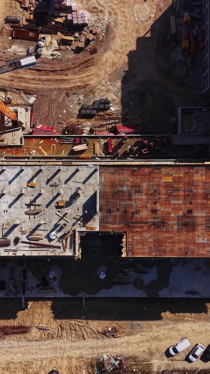 Workers on concrete floor slab aerial perspective