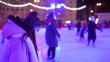 woman ice skating at a christmas night rink