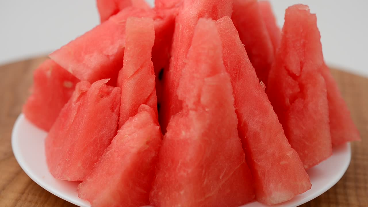 Shooting of a watermelon on a kitchen board. Shooting in the movement