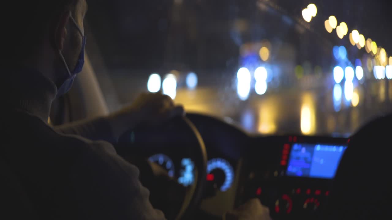 의료 마스크를 입은 젊은 남자가 밤의 도시 도로를 달리고 있습니다.