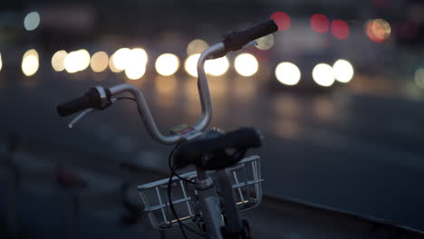 shared bicycle standing on street at road guardrail close up. city mobility.