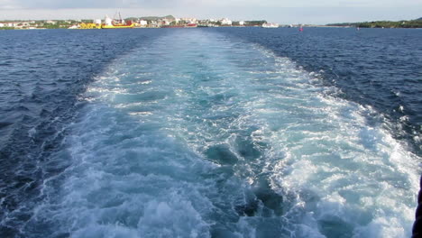 splash track of the leaving ferry from the port of bohol, philippines