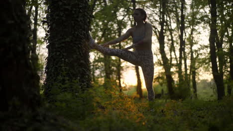 woman stretching in the forest